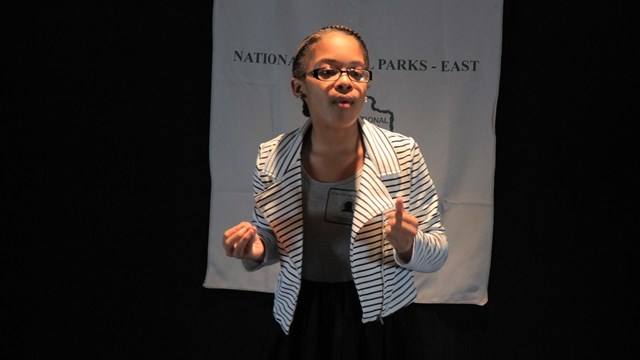 A student delivers a speech to an audience