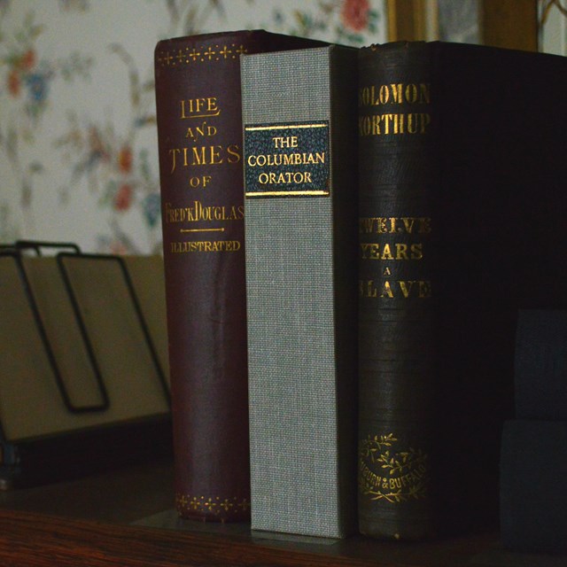 Three books on top of a desk