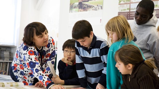 A landscape architect shows students a plan during a visit to her office