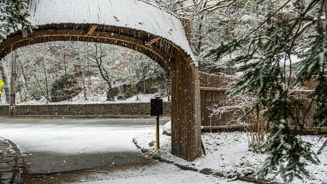 Snowflakes fall around the entry.