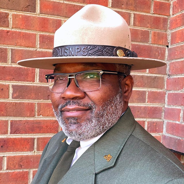 A portrait of a park ranger in dress uniform.