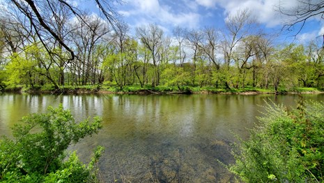 A view across the Brandywine River on a partly cloudy day. 