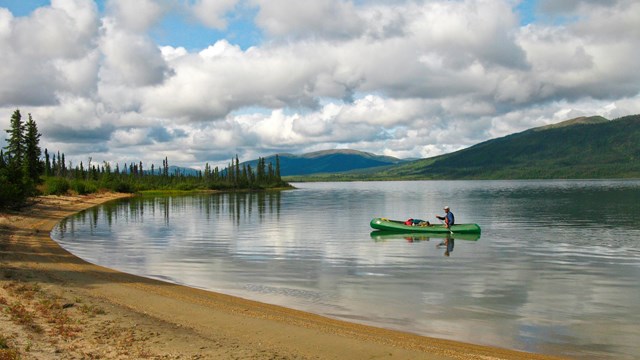 A person canoeing on a lake in the Brooks Range