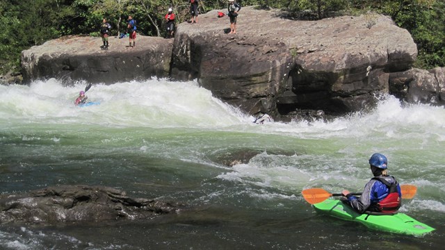 Kayers and rafters on going through the rapids on the Gauley River National Recreation Area