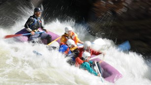 Raft going through a rapid