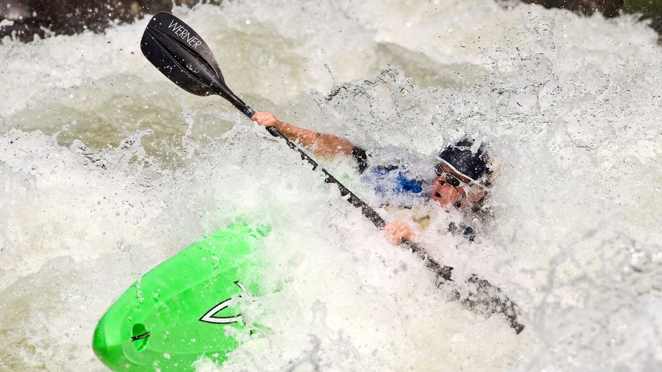 Kayaker paddling through a rapid on the Gauley River