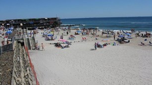 Visitors on the sand at one of Gateway's beach clubs