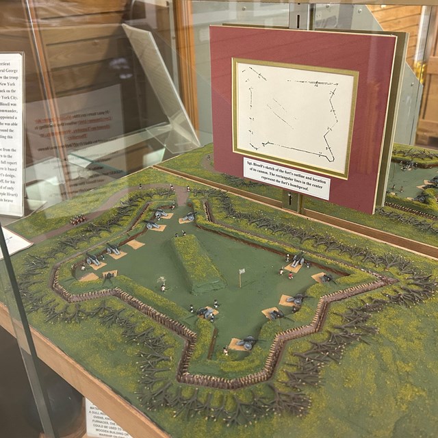 a diorama and drawing of a military fort from the revolutionary war