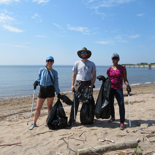 Two volunteers and ranger on beach