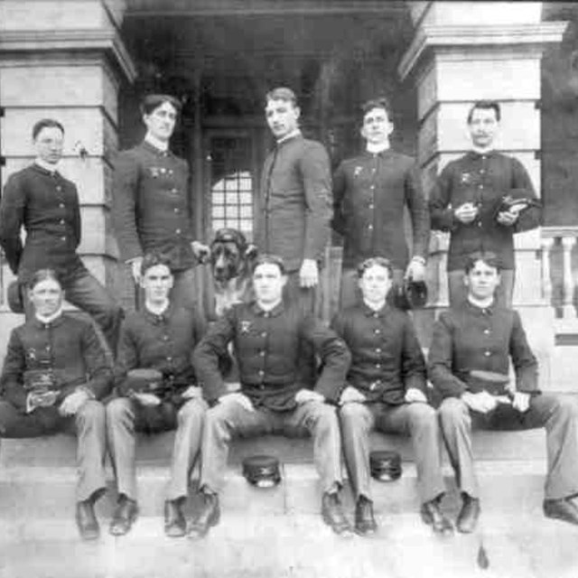 Group of soldiers at Sandy Hook. Middle soldier in front row is Tom Mix, a movie star