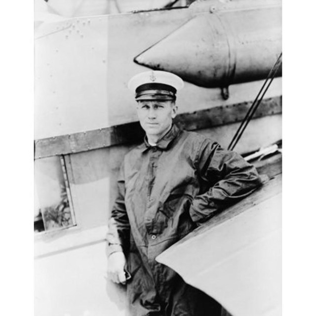 Floyd Bennett beside an airplane