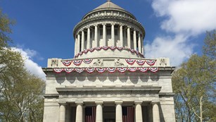 Front of Mausoleum in sunlight with flags and bunting