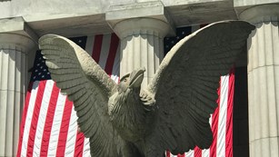 Eagle statue with with flags and columns of Mausoleum