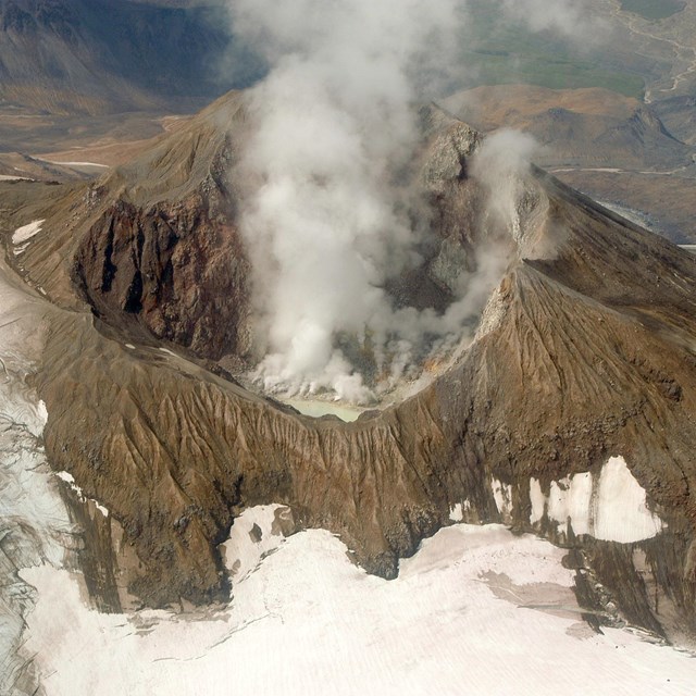 volcano caldera with steam rising