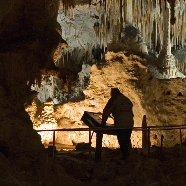 visitor in large lighted cave