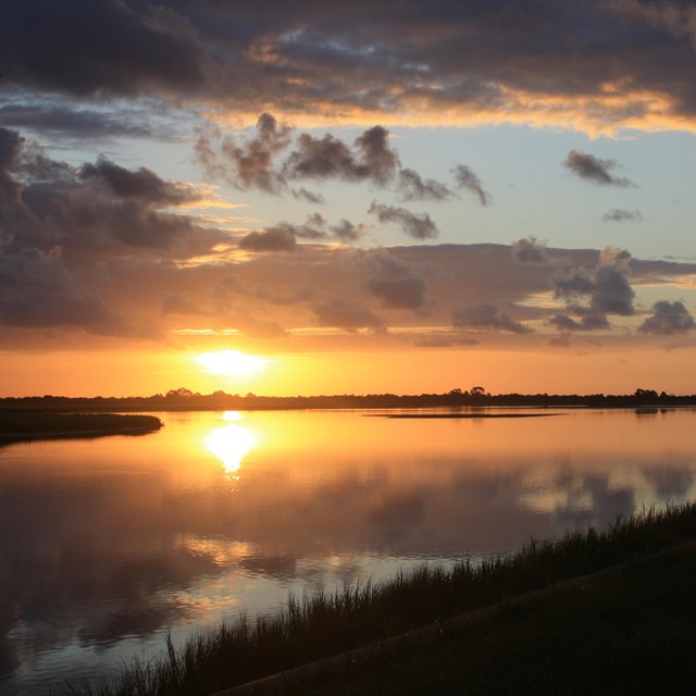 sunrise over open water estuary