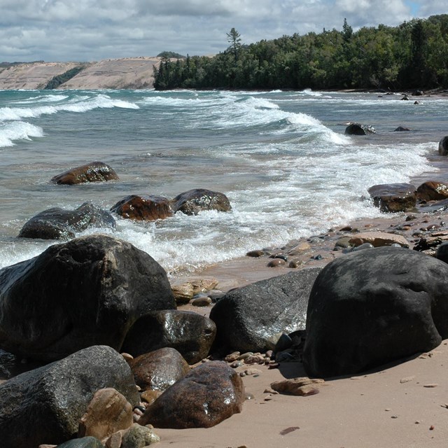 boulders and cobbles on a sandy beach