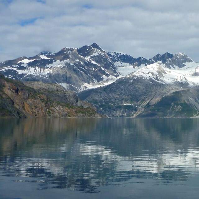 open water bay with mountains in distance