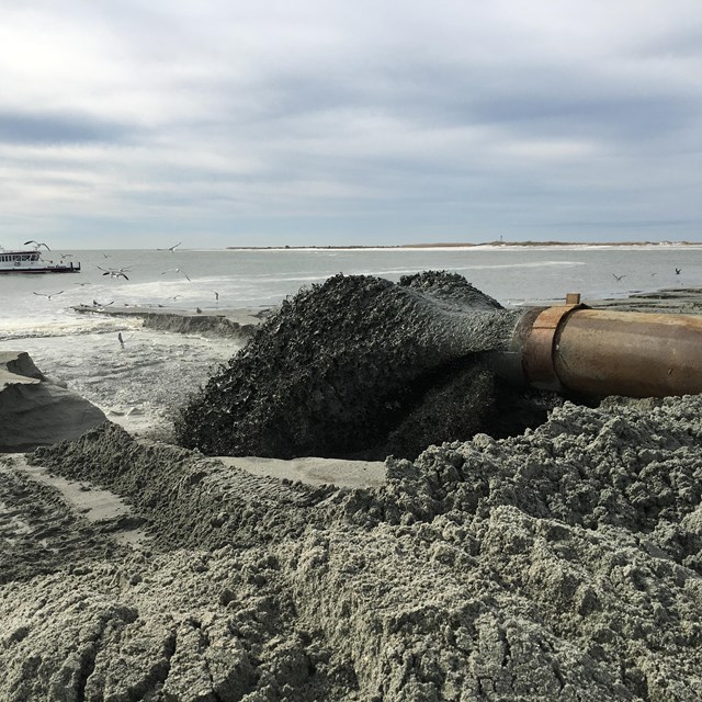 sand being pumped on to a beach