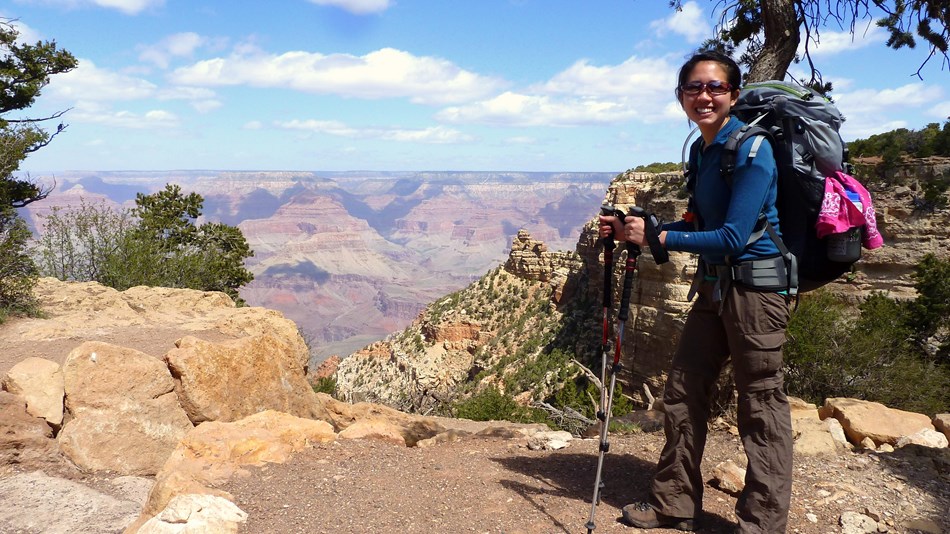 person standing near a Grand Canyon viewpoint