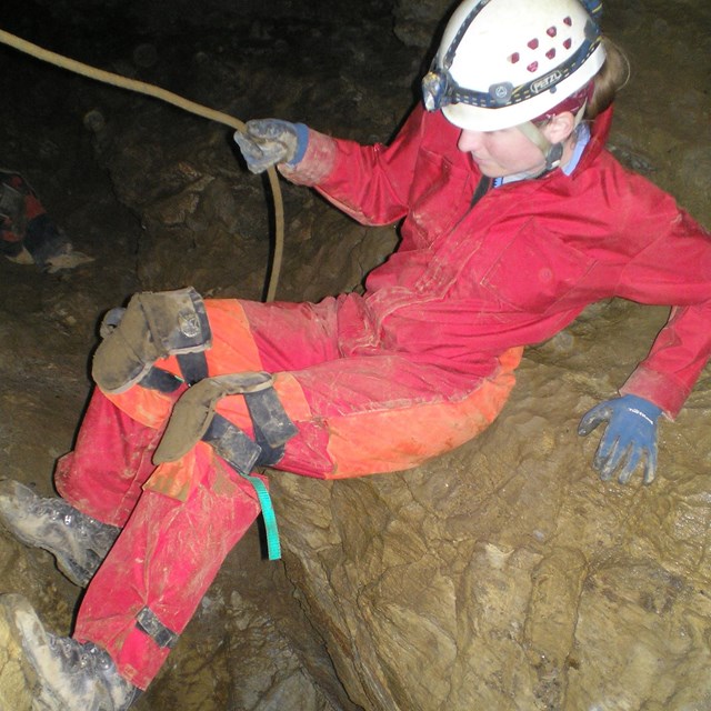 person exploring a cave