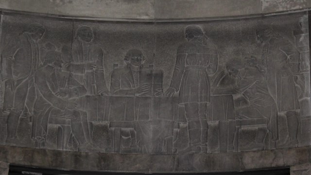 Stone carving depicting Clark receiving orders to attack the British western frontier outposts