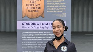 Intern standing in front of a poster