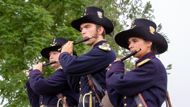 Three fife players in United States Civil War dress.