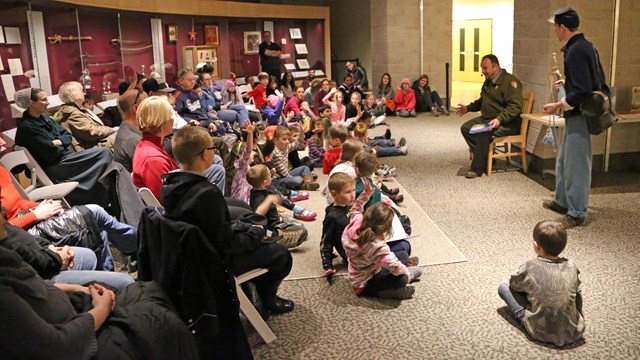 A Park Ranger Reads a Book to a Group of Young Children