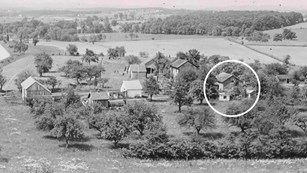 A black and white photo shows the Warfield house property in the early 1900s.