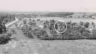 A black and white photo shows the Warfield house property in the early 1900s.