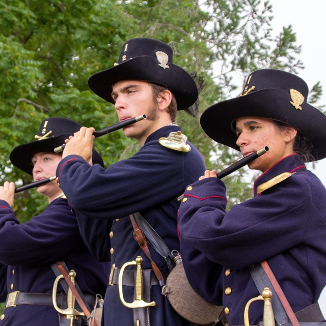 Three fife players in United States Civil War dress.