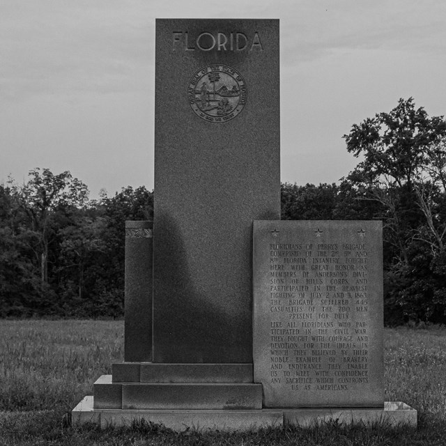 A black and white photo of a monument with Florida engraved on the top.