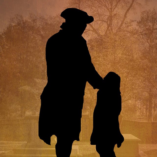 A silhouette of a man and a boy.