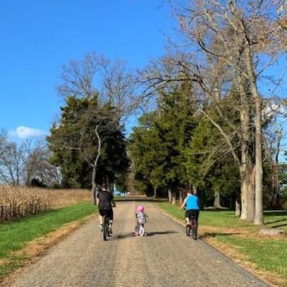 Three bicyclists on road to the Potomac River Beach