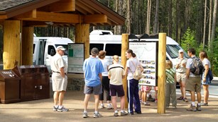 Busy shuttle stop at Apgar Visitor Center