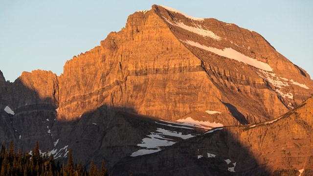 sloping mountain with dark rock band