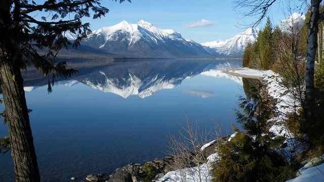 snowy mountain reflected in still lake