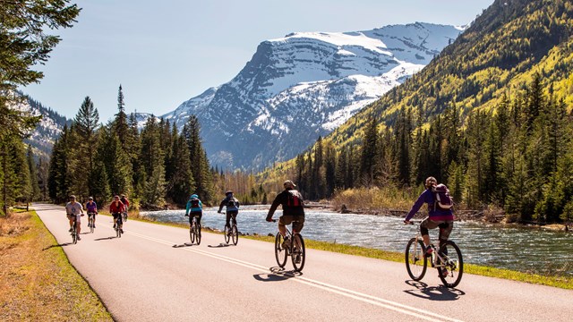 Visitors biking the road along McDonald Creek during hiker/biker season