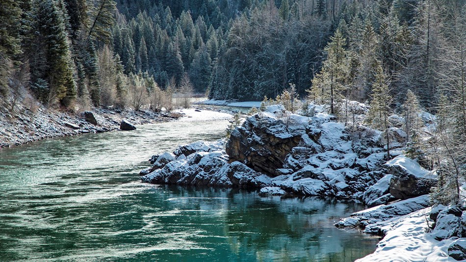 Photo of the Middle Fork of the Flathead River with new snow on the sides