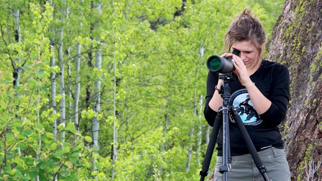 Teen girl looks into spotting scope