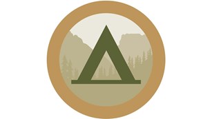 graphic circle with a tent symbol