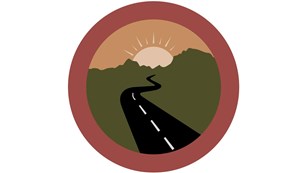 round graphic of park road and mountains in the distance