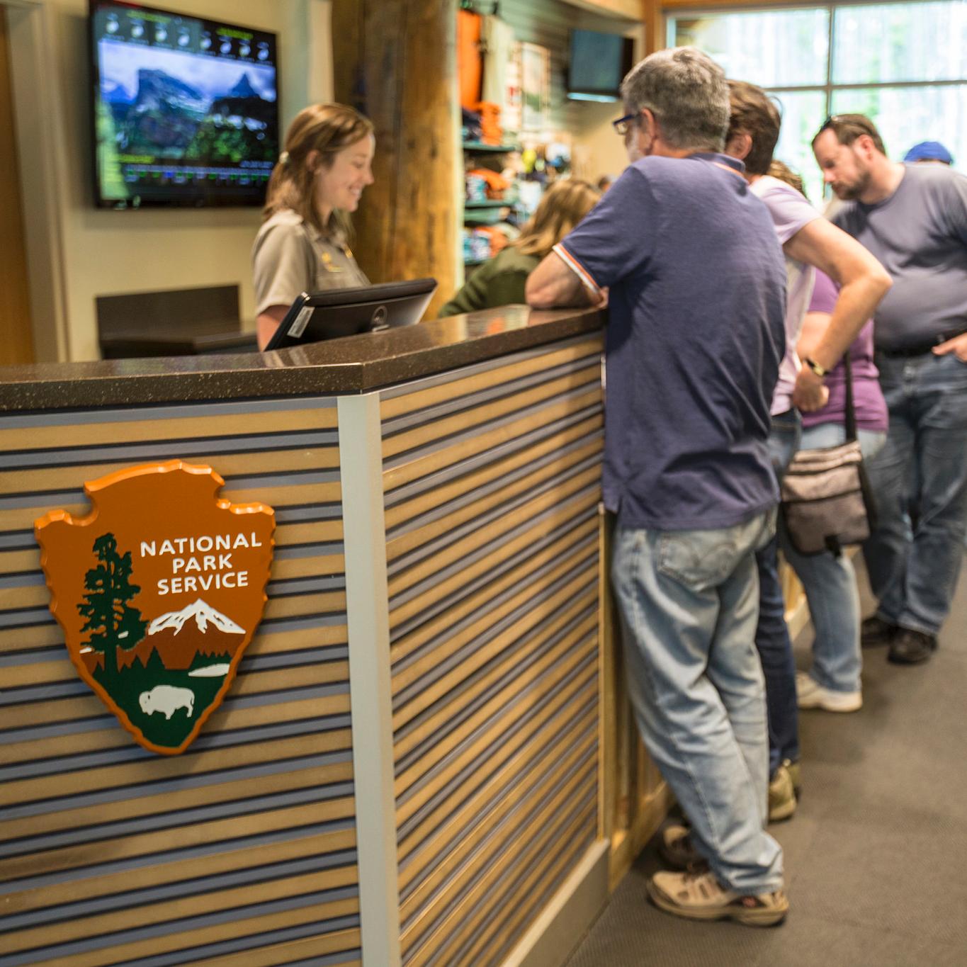 Ranger talking to park visitors at an information desk