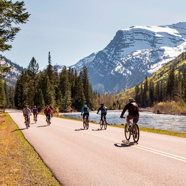 Visitors biking the road along McDonald Creek during hiker/biker season