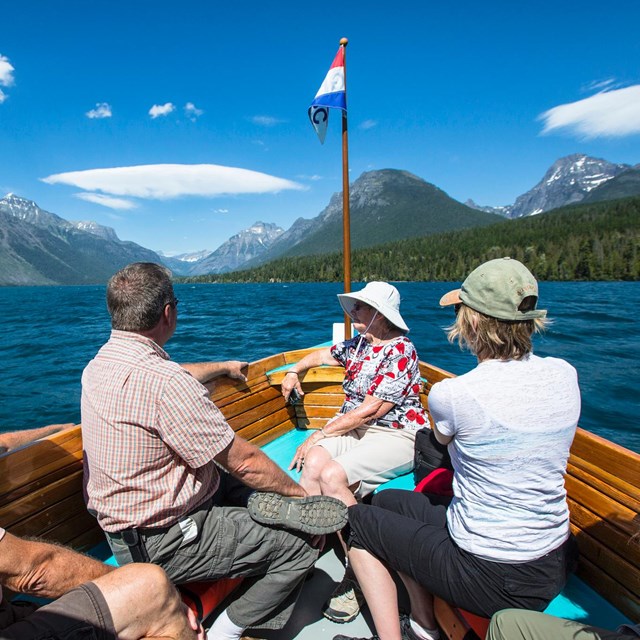 Visitors enjoying a boat tour of Lake McDonald