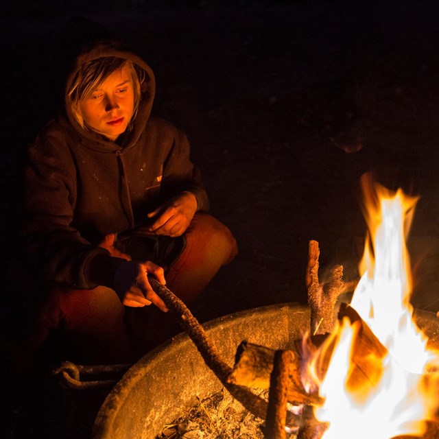 Visitor by campfire