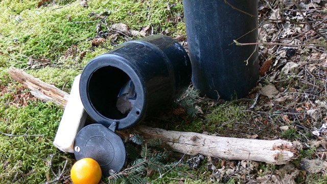 two black cylinder canisters