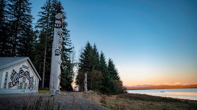 Two totem poles in front of the Huna Tribal House