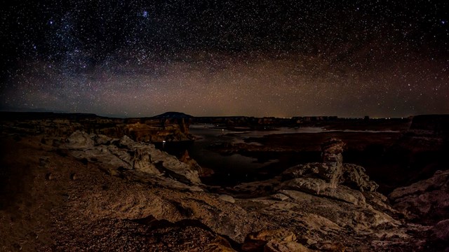 Starry sky over Alstrom Point and Lake Powell below